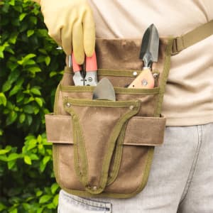 A garden tool waist pouch in brown with green accents, featuring multiple pockets for tools.