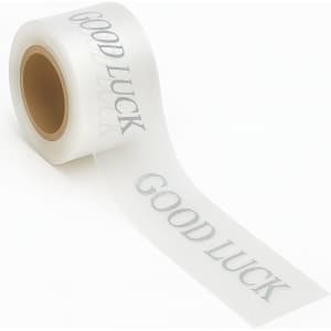 A roll of clear adhesive ribbon with a silver "Good Luck" message printed across it.