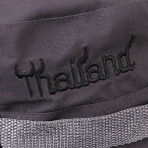 A black hat featuring a grey band and an embroidered "Thailand" detail.