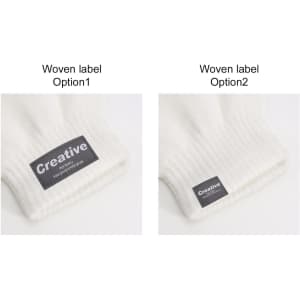 A pair of white knitted gloves featuring woven labels in different styles on the cuffs.