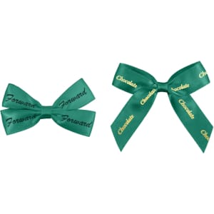 Two green adhesive bows, one larger and one smaller, both featuring text in gold. One has "Forward" and the other "Chocolate".