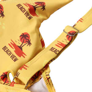 A yellow bikini top featuring palm tree and sunset designs, with adjustable straps and a logo.
