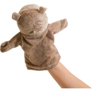 A brown plush hippopotamus hand puppet with small ears and arms, held up by a hand.