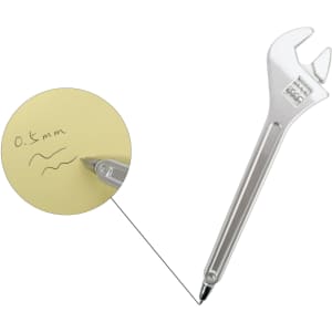 A silver ballpoint pen shaped like a spanner rests next to a note with handwritten text on it.