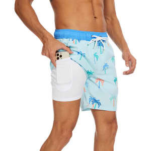 Men's swim shorts in light blue featuring palm tree patterns, with a side pocket and a contrasting waistband.