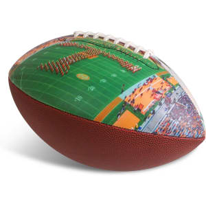 A promotional American football with a textured brown surface and vibrant printed graphics of a sports field.