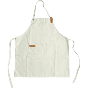 A cream-coloured poly-cotton canvas full bib apron with a neck strap and a front pocket. It features a logo.
