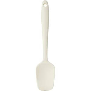 A silicone spatula in a light cream colour with a long handle and a rounded head. It features a hole for hanging.