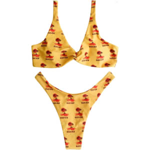 A yellow bikini bottom with a palm tree pattern and a logo. It features a high-cut design.