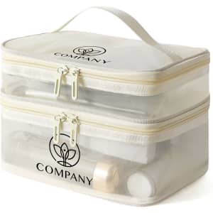 A double-layer cosmetic bag in cream nylon mesh with zippers and a handle, featuring a logo on the front.