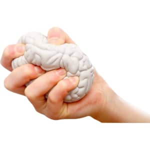 A white brain-shaped stress reliever held firmly in a hand, showcasing its unique design and texture.