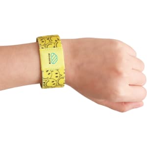 A yellow stretchy wristband featuring a smiley face design and a logo on the side, worn on a wrist.