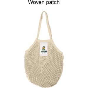 A beige mesh grocery bag with a woven patch and logo, featuring two handles for easy carrying.