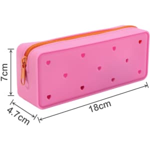 A pink silicone pencil case with cut-out heart shapes and a zipper closure, measuring 18 cm by 7 cm by 4.7 cm.