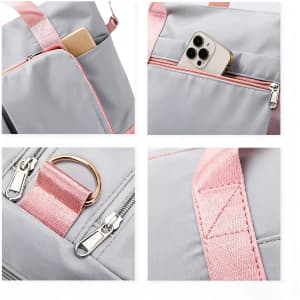 A grey foldable sports duffle bag with pink accents, featuring a pocket holding a smartphone and zippers.
