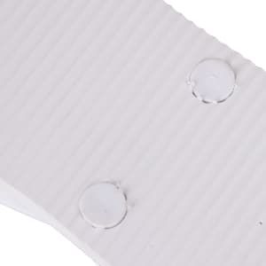 A close-up of white EVA material with ribbed texture and circular indentations. The image features a logo.