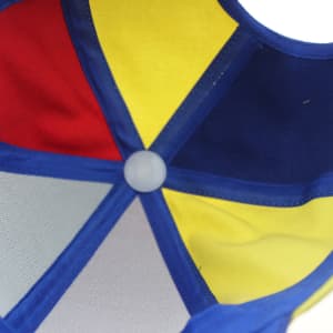A blue cap featuring a multi-coloured interior with red, yellow, and blue panels, and a central button.