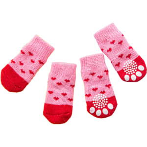 Pet socks in pink and red with heart patterns and non-slip grips on the bottom. Includes four individual socks.