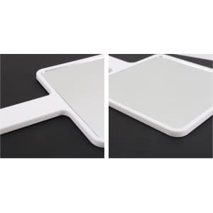 A handheld square mirror with a white frame, shown from two angles on a dark background.