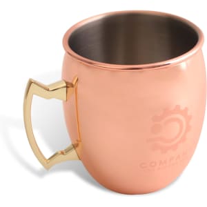 A copper mug with a shiny gold handle, featuring a logo on the side and a sleek interior.