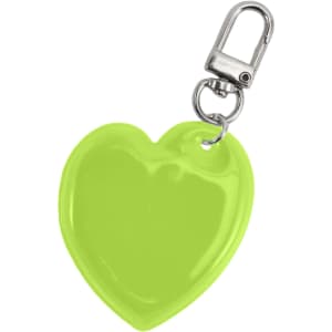 A heart-shaped reflective keychain in bright lime green with a metal clip.