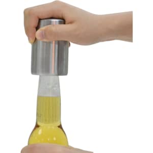 A drink bottle opener with a metallic finish, being used to open a beer bottle.