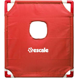 A red portable cornhole game board featuring a central hole and a logo.