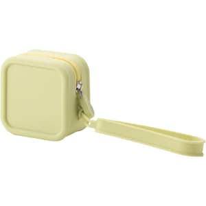 A square silicone coin pouch in a light yellow shade with a zip closure and wrist strap. It has a logo on the surface.