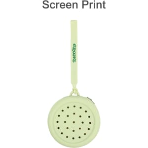A round, pale green silicone pouch with holes, featuring a loop handle and a logo.