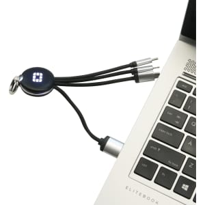A round-shaped light-up charging cable in black with multiple connectors, plugged into a laptop's USB port.