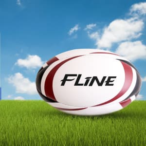 A rugby ball with red and black stripes on a grassy surface, featuring a logo.
