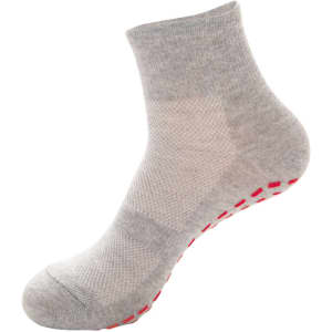 A pair of grey crew socks with a non-slip red grip pattern on the sole. Features a smooth texture and mid-calf height.