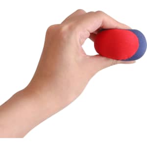 A hand holds a red and blue water bouncing ball, made of soft material, featuring a smooth surface.