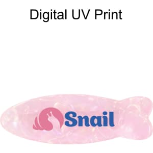 A fish-shaped hair clip in iridescent pink, featuring a logo in blue.