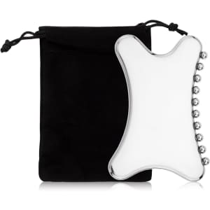 A Gua Sha tool in a clear, curved design beside a black carrying pouch. The tool features rounded edges and silver accents.