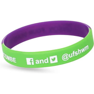 A green and purple silicon wristband featuring a logo and social media handles.