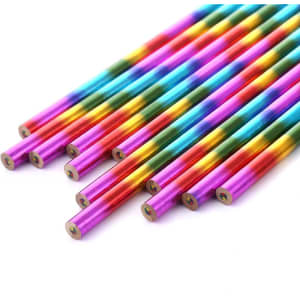 A set of long, vibrant four-colour pencils in shades of pink, blue, green, and gold, arranged in a group.