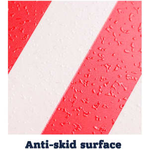 A close-up of a red and white anti-skid serving tray surface with textured stripes.