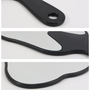 A tooth-shaped face mirror in black, featuring a smooth reflective surface and a hole for easy handling.