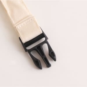 A beige linen bread bag with a black plastic fastening clip. The product features a simple, minimalist design.