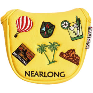 A yellow custom mallet putter cover featuring various embroidered designs, including a hot air balloon, palm trees, and a drink.