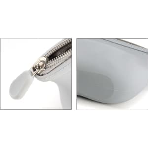 A grey silicone cosmetic bag featuring a zip closure and a rounded base, with a silver zipper pull.