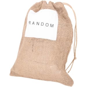 A jute net produce bag in a natural tan colour with a white label featuring text, and a drawstring closure.