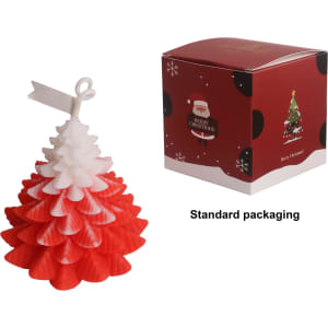 A red and white Christmas tree-shaped candle next to its festive packaging featuring a Christmas design.