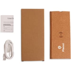 A cork wireless charger in a foldable design, accompanied by a user manual and a charging cable. It has a simple, natural appearance.
