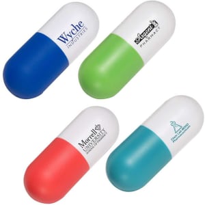 A capsule-shaped stress reliever in blue, green, red, and teal, featuring various logos on each side.
