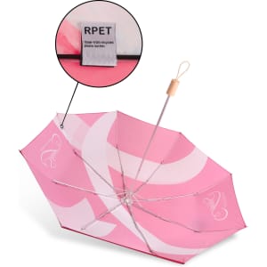A lightweight pink umbrella with a wooden handle and a label indicating it’s made from recycled plastic bottles.