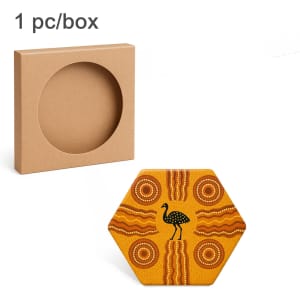A hexagonal ceramic coaster in yellow with Aboriginal-inspired patterns, packaged in a plain brown box.