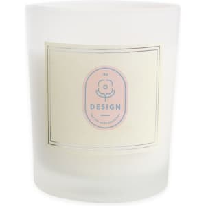 A frosted glass candle featuring a light-coloured label and a logo, designed for home decor.