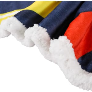 A close-up of a vibrant blanket featuring navy blue, red, and yellow colours with a plush white edge.